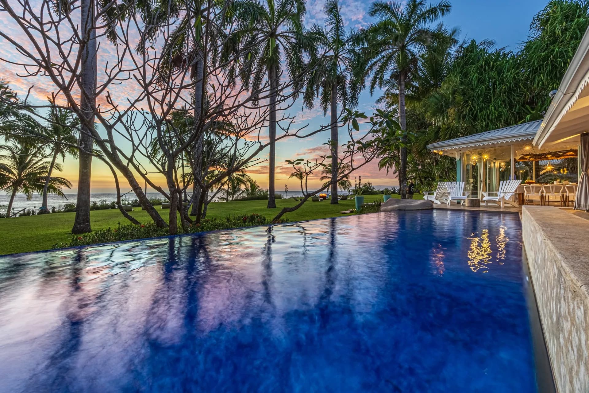 Villa Diosa del Mar — the pool at dusk between the palms